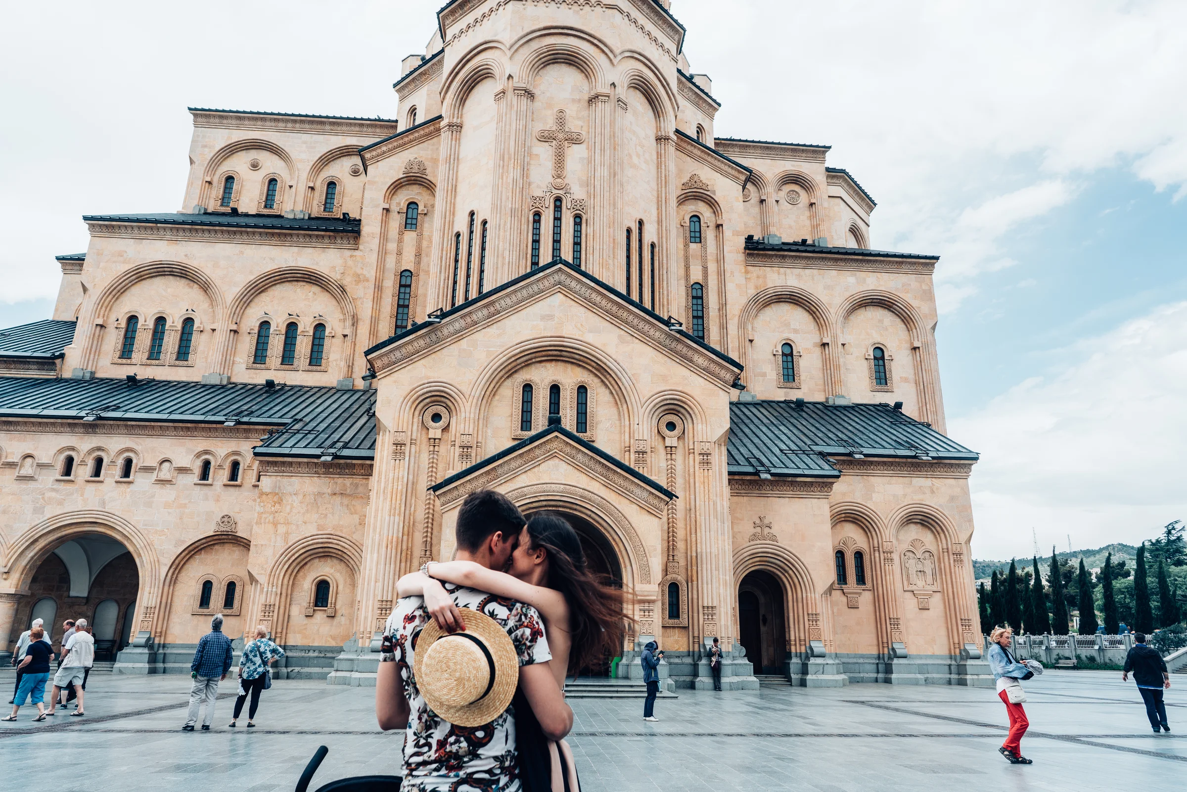 Young couple on a tree-lined street in Tbilisi