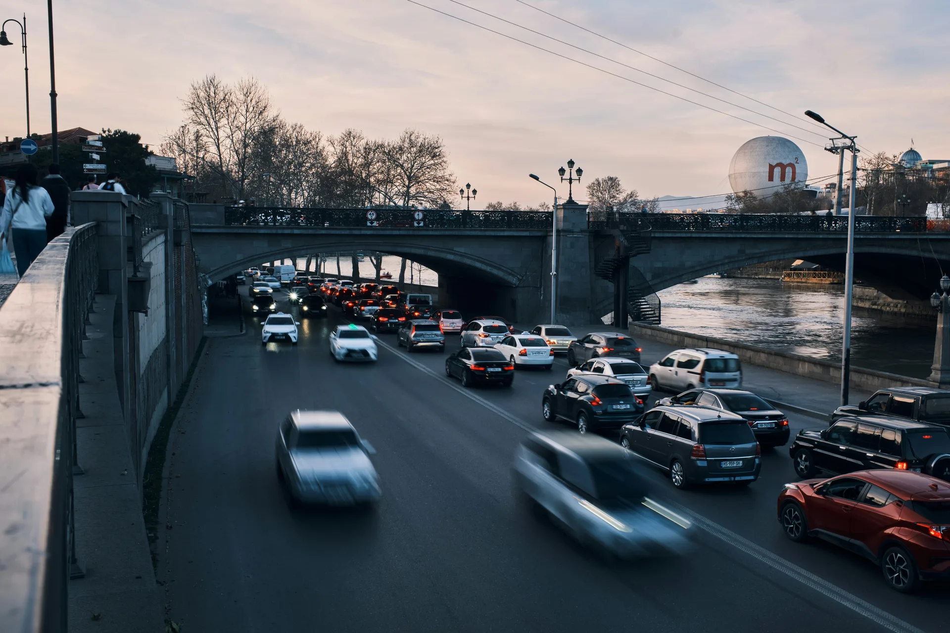 Evening traffic on a bridge over the Kura River in Tbilisi