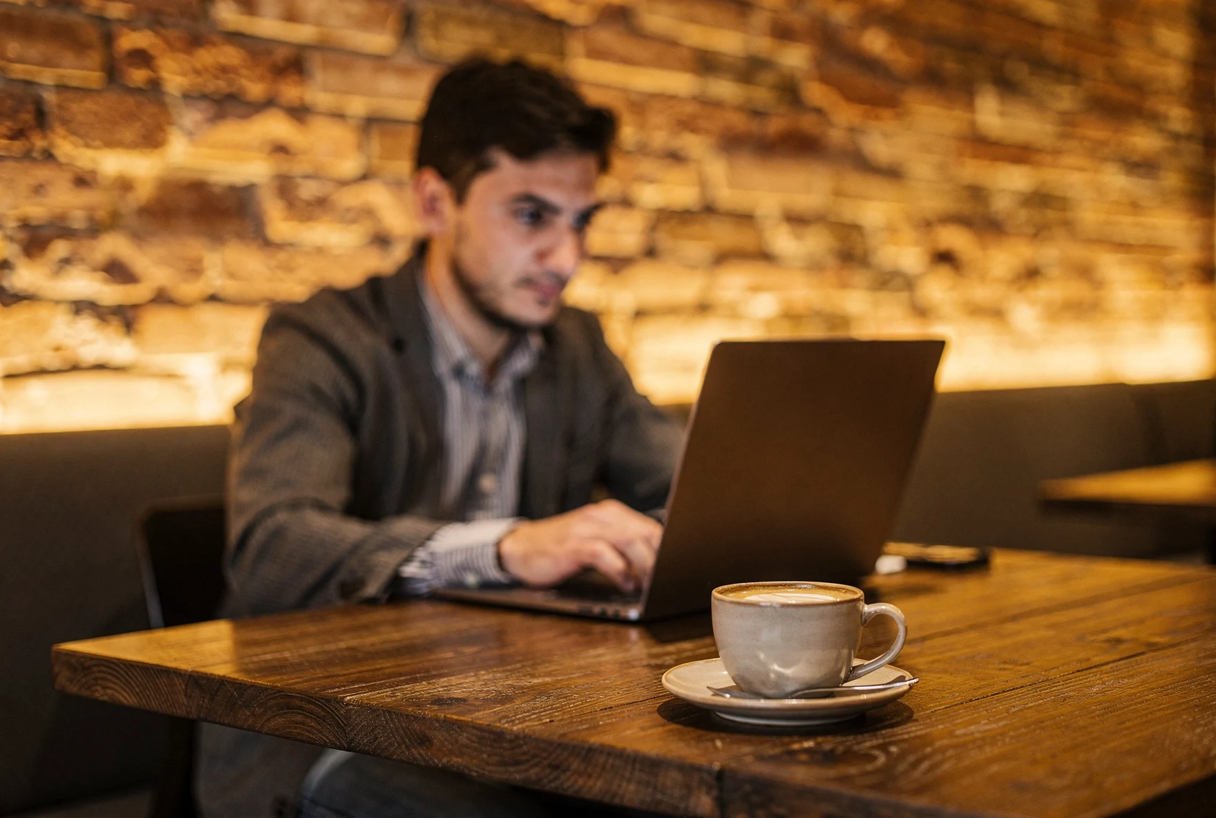 Person working on laptop at a cozy Tbilisi cafe