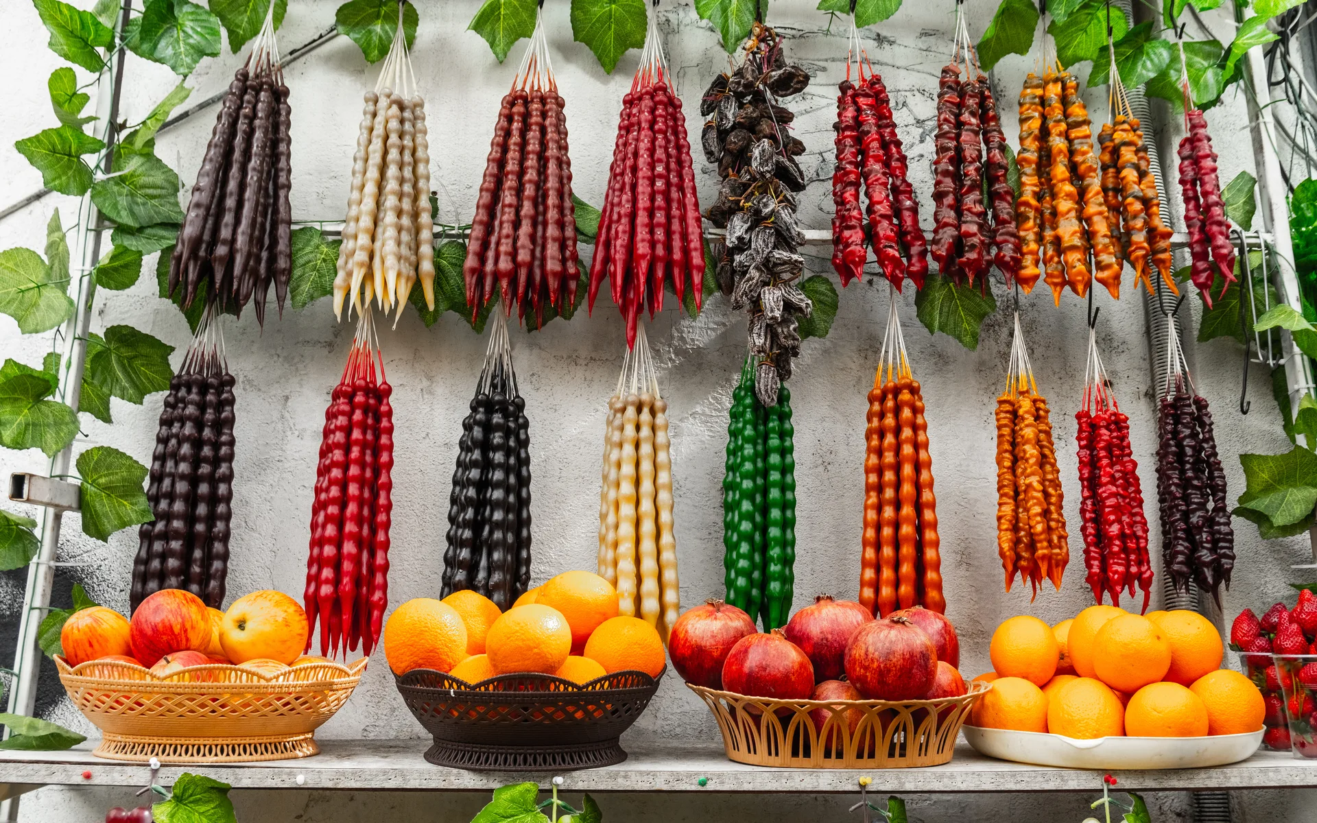 Traditional Georgian market stall displaying churchkhela and dried fruit