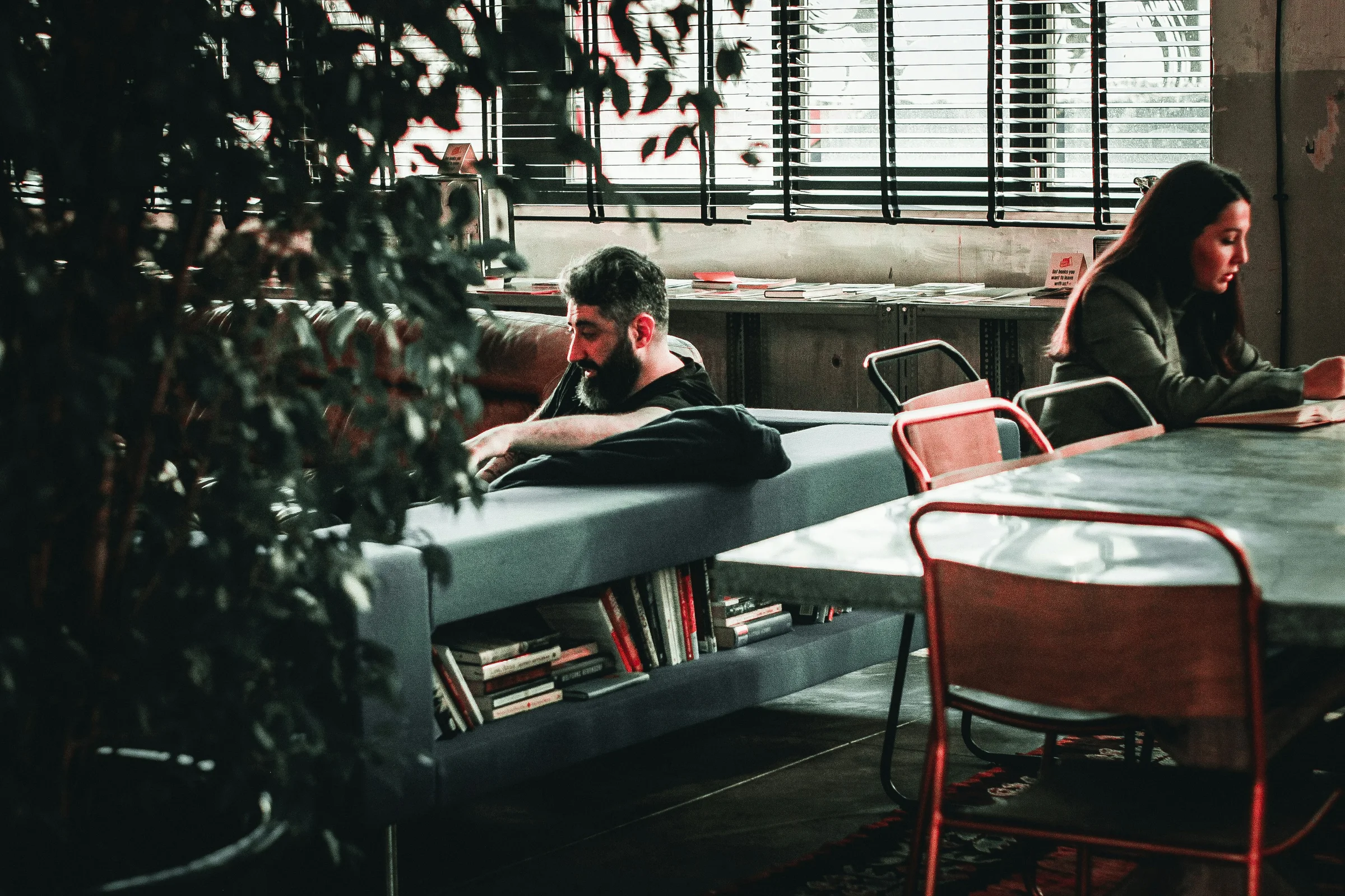 Person working on a laptop at a café in Tbilisi with a view of the old town