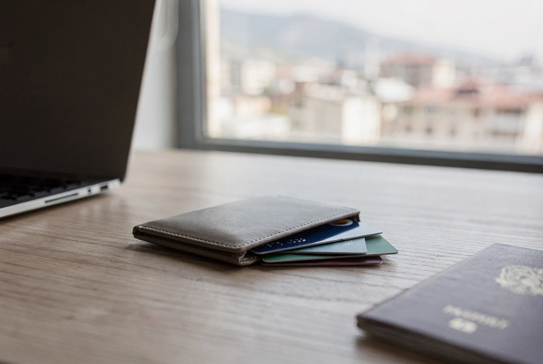 Passport, bank cards and laptop on a desk ready for expat banking setup in Georgia