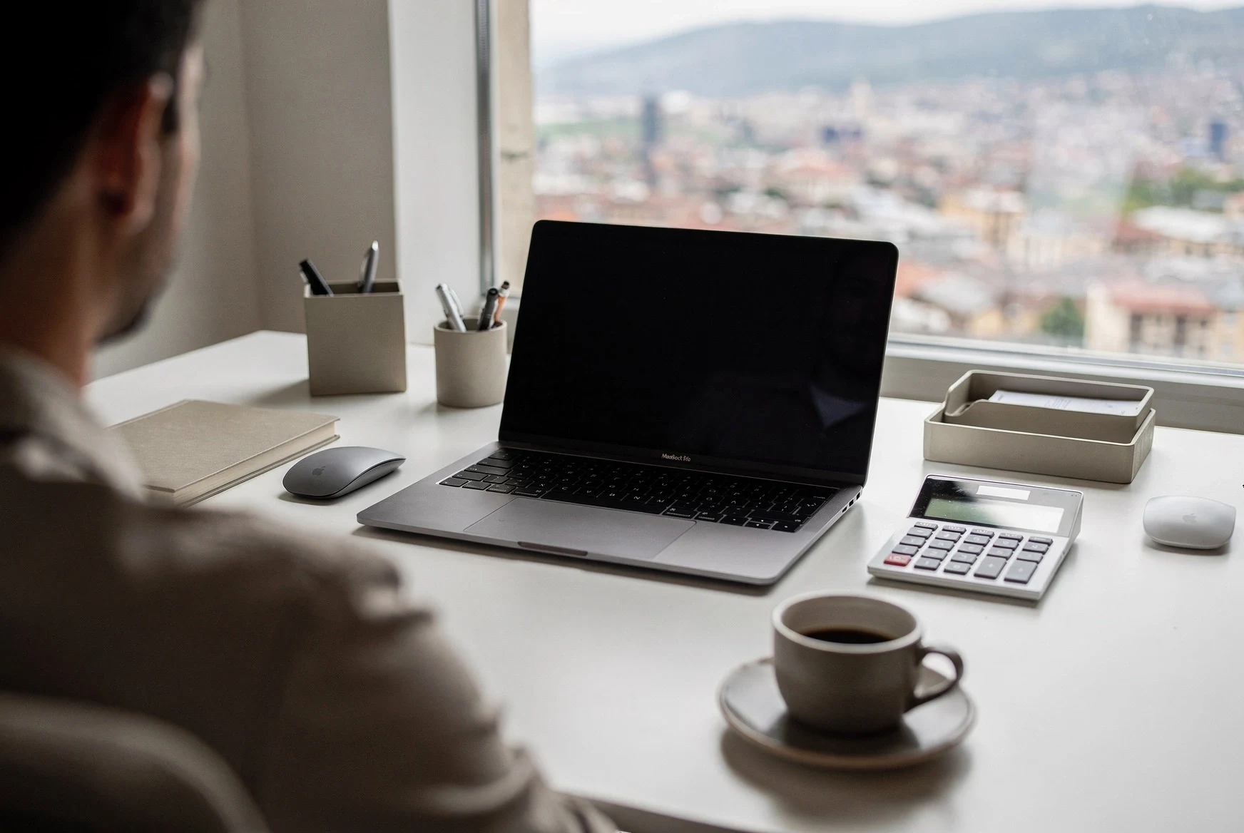 Tidy desk with laptop, notebook, and calculator prepared for a Revenue Service export
