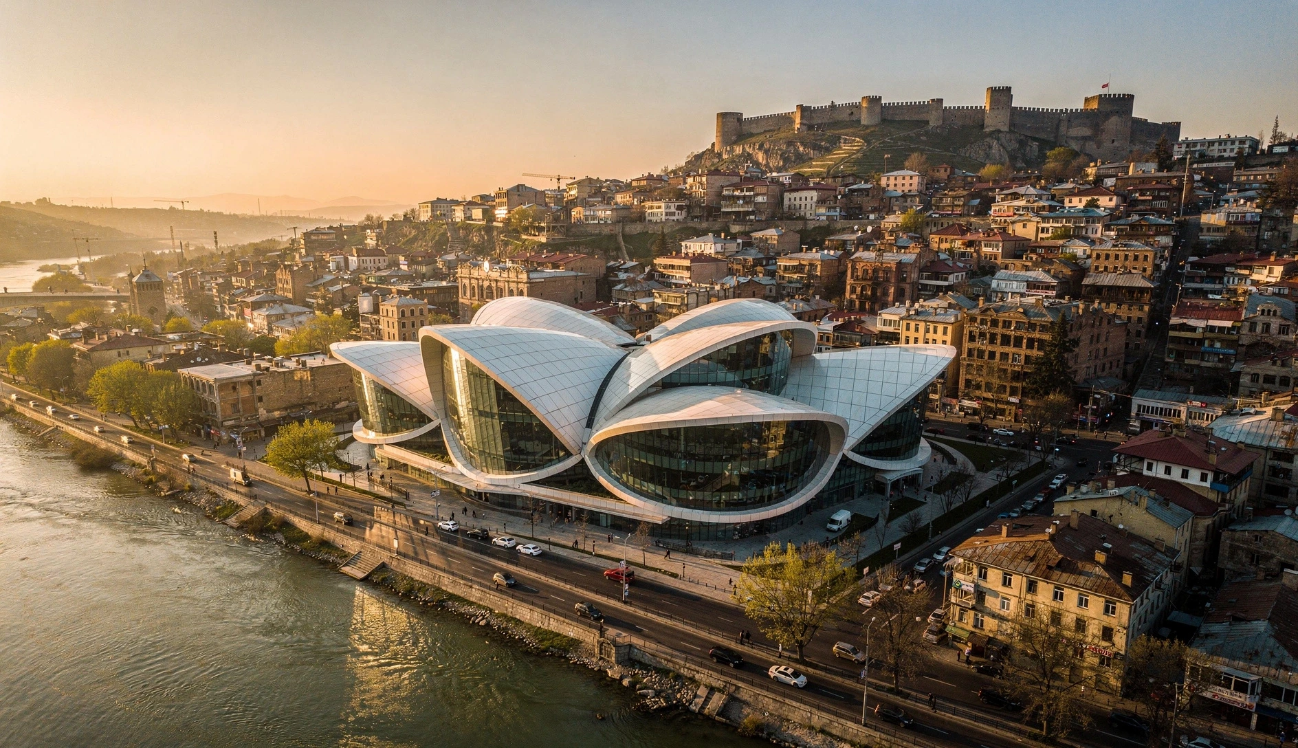 Aerial view of Tbilisi with the Public Service Hall on the Kura riverbank at golden hour